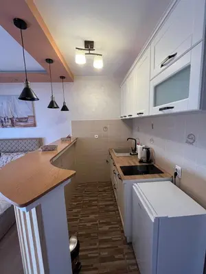 a small kitchen with white cabinets and a sink at ANDREA in Mali Mokri Lug