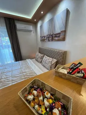 a room with a bed and a table with food on it at ANDREA in Mali Mokri Lug
