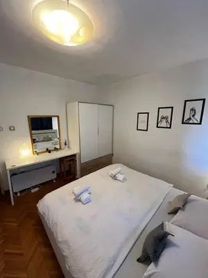 a bedroom with a large white bed and a desk at İstanbul apartment 2 in Belgrade