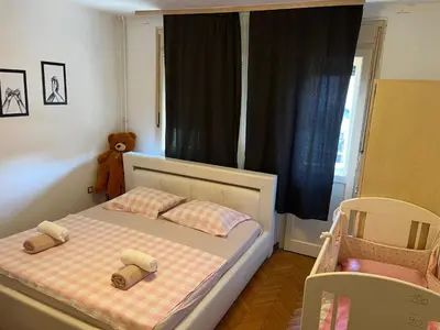 a small bedroom with a bed with two pillows at İstanbul apartment 2 in Belgrade