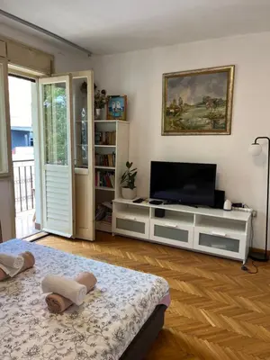 a living room with a television and a white entertainment center at İstanbul apartment 2 in Belgrade