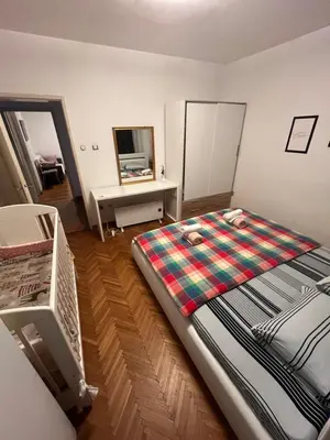 a bedroom with a bed and a desk with a mirror at İstanbul apartment 2 in Belgrade