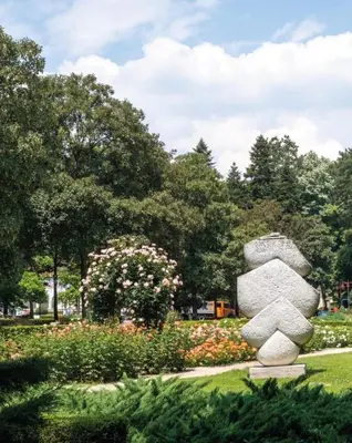 a rock sculpture in the middle of a park at Apartman Krejović in Arandjelovac