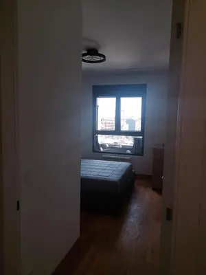 a bedroom with a bed in front of a window at Jana apartment in Belgrade