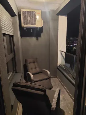 a living room with a chair and an air conditioner at Jana apartment in Belgrade
