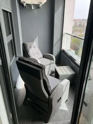 a small room with a chair and a chair at Jana apartment in Belgrade