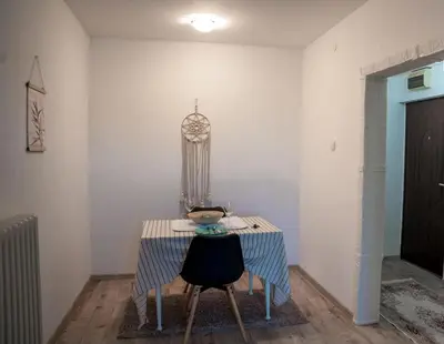 a table with two chairs and a bowl on it at Tea Apartman Obrenovac in Obrenovac
