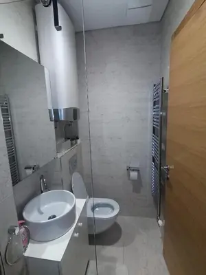 a bathroom with a sink and a toilet at Skyline Studio Belgrade in Belgrade
