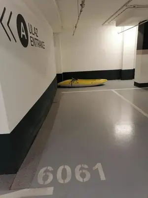 a room with a surfboard on the floor next to a wall at Skyline Studio Belgrade in Belgrade