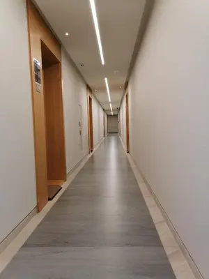 a long corridor with white walls and a long hallway at Skyline Studio Belgrade in Belgrade