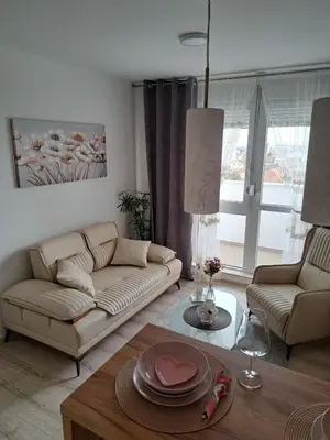 a living room with a couch and a table at Apartman Bross in Ruma