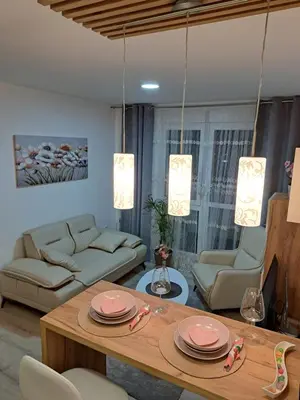 a living room with a table and a couch at Apartman Bross in Ruma