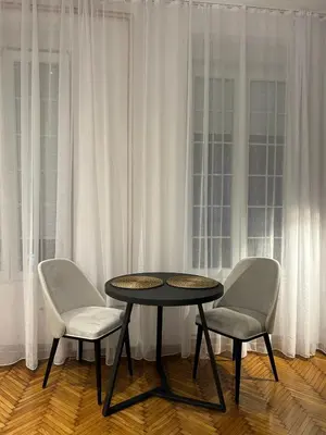a table and two chairs in front of a window at KaLuMa2 in Belgrade