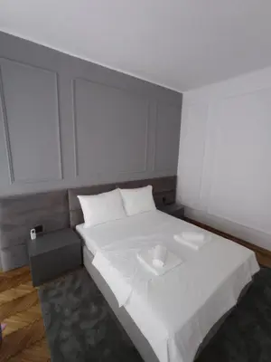 a bedroom with a white bed with a tray on it at KaLuMa2 in Belgrade