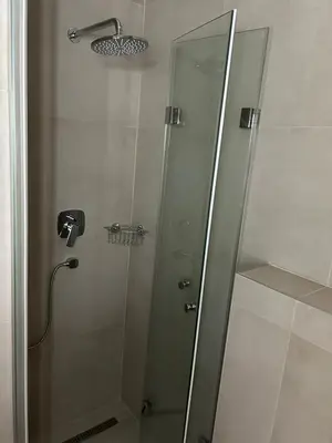 a shower with a glass door in a bathroom at KaLuMa2 in Belgrade