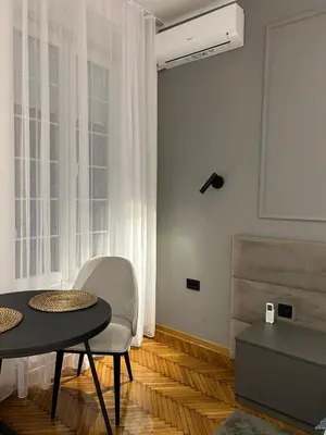 a living room with a table and a chair at KaLuMa2 in Belgrade