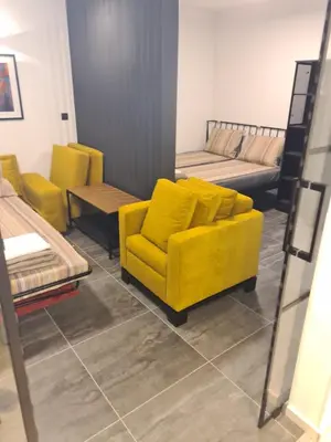 a living room with a yellow couch and tables at Runaway Hill in Bežanija