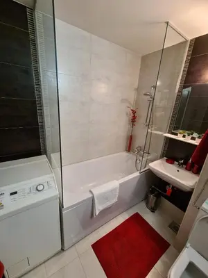 a white bathroom with a tub and a sink at Runaway Hill in Bežanija