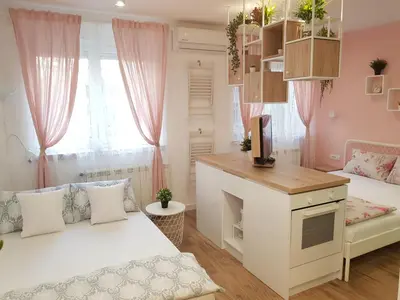a small room with two beds and a desk at VeryBell in Belgrade