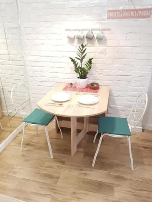 a wooden table with two chairs and a plant on it at VeryBell in Belgrade