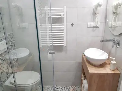 a bathroom with a shower and a toilet and a sink at VeryBell in Belgrade