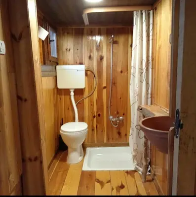 a bathroom with a toilet and a sink at Log cabin in Belgrade