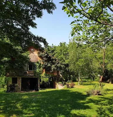 an old house in the middle of a field at Log cabin in Belgrade