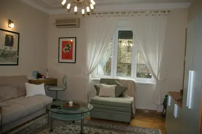 a living room with a couch and a table and a window at DeeM-LUX in Belgrade