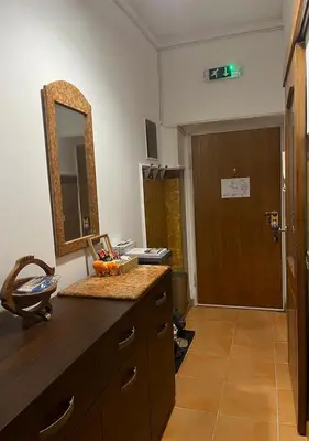 a bathroom with a vanity with a mirror and a door at DeeM-LUX in Belgrade