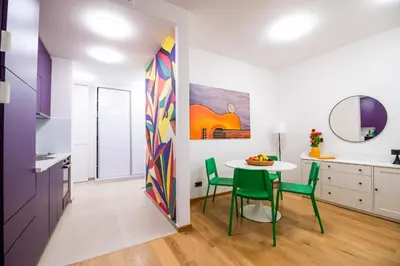a kitchen and dining room with a table and chairs at City Center - Colors Apartment with Garage in Belgrade