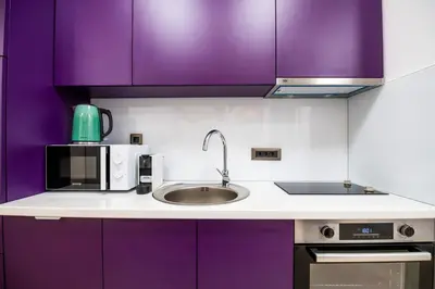 a kitchen with purple cabinets and a sink at City Center - Colors Apartment with Garage in Belgrade
