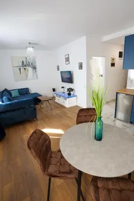 a living room with a table and a couch at DreamLand Apartment in Surčin