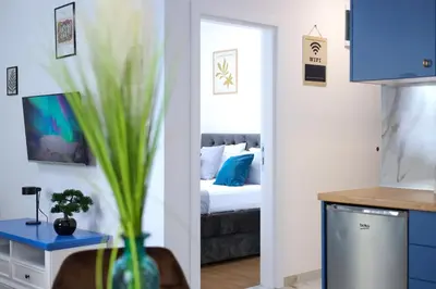 a room with a bed and a vase with a plant at DreamLand Apartment in Surčin