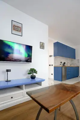a kitchen with blue cabinets and a blue table at DreamLand Apartment in Surčin