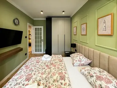a bedroom with a bed and a flat screen tv at Momentum in Belgrade