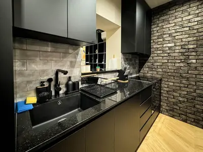 a kitchen with a sink and a brick wall at Momentum in Belgrade