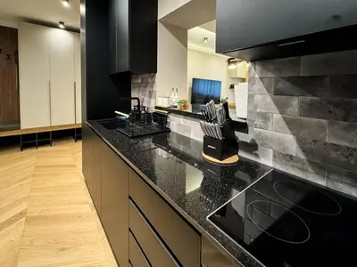a kitchen with black granite counter tops and cabinets at Momentum in Belgrade