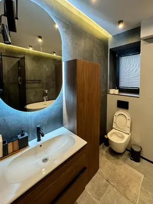 a bathroom with a sink and a toilet and a mirror at Momentum in Belgrade