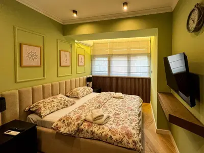 a bedroom with a bed and a television in it at Momentum in Belgrade