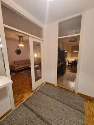 a living room with a door leading to a dining room at 70 square meters in Block 61 in Bežanija