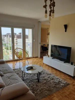 a living room with a couch and a flat screen tv at 70 square meters in Block 61 in Bežanija