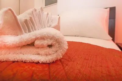 a pile of white towels sitting on top of a bed at Atelier 1 Apartment in Belgrade