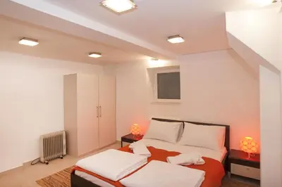 a bedroom with a bed and two lamps in it at Atelier 1 Apartment in Belgrade