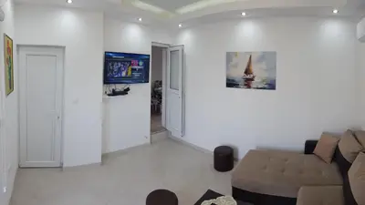 a living room with a couch and a tv at BigNest in Smederevo