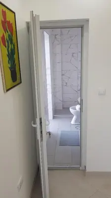 a bathroom with a glass door leading to a shower at BigNest in Smederevo