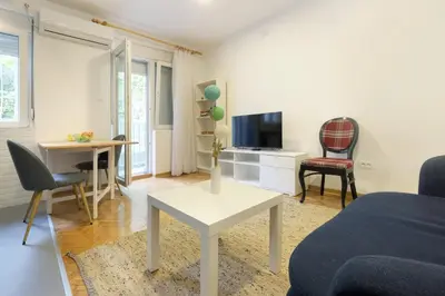 a living room with a couch and a table at The 7 Apartment - Modern Flat with Terrace near Parliament, Belgrade Center in Belgrade