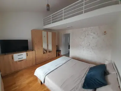 a bedroom with a large bed and a tv at Nemanjina Centar in Pančevo