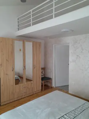 a bedroom with a bed and a loft at Nemanjina Centar in Pančevo