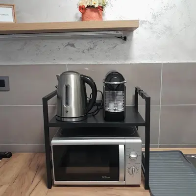 a microwave on a stand with a coffee maker on it at Nemanjina Centar in Pančevo