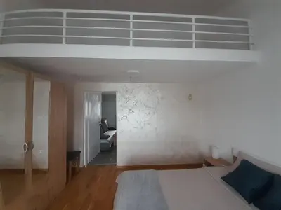 a bedroom with a bed and a white ceiling at Nemanjina Centar in Pančevo